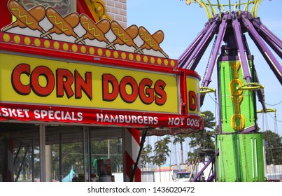 Tyler, TX - September 28, 2011: Corn Dog Sign And Carnival Ride At Local Street Carnival