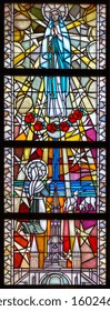 Tylicz, Poland. 2019/8/8. Stained-glass window depicting Our Lady of Lourdes appearing to Bernadette Soubirous in the cave of Massabielle. The Sanctuary of Our Lady of Tylicz.