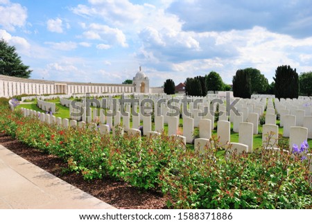 Tyne Cot Commonwealth War Graves Cemetery with rotunda, trees and flowers on a sunny day, outside Passchendale, near Zonnebeke in Belgium