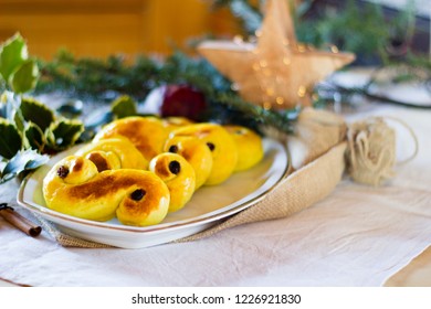 Typcial traditional Swedish saffron buns for the Christmas holidays and Ludia Day in December called "Lucia buns" or also "Lussekatter".  Selective focus - Shutterstock ID 1226921830