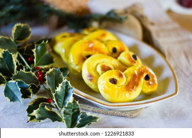 Typcial traditional Swedish saffron buns for the Christmas holidays and Ludia Day in December called "Lucia buns" or also "Lussekatter".  Selective focus - Shutterstock ID 1226921833
