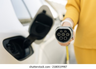 Type 2 CCS plug port cable on electric vehicle. Fast charging socket type 2 combo electric car. DC - CCS type 2 EV charging connector at EV car. Eco friendly alternative energy green environment