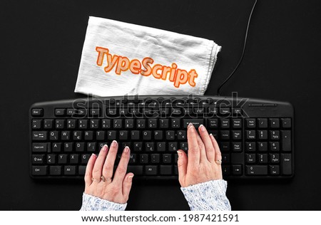 TypeScript programming language. Rag width word TypeScript and hands on pc keyboard 