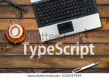 TypeScript Programming Language. Word TypeScript on wooden desk and laptop 