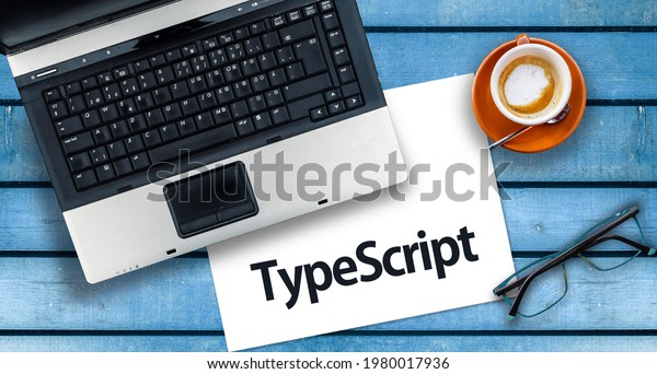 TypeScript Programming Language. Word TypeScript\
on paper and laptop