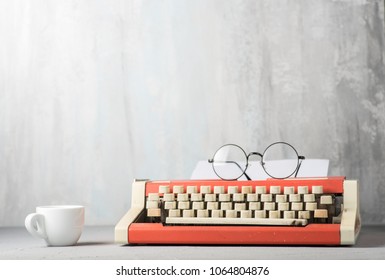 A typewriter and an espresso cup