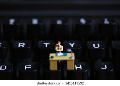 typewriter with the figurines in work