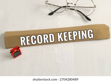 Typewriter model, spectacle and record keeping words on white wooden view background