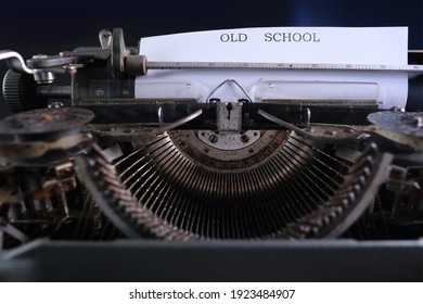 typewriter on table, words fake news are printed on paper in large size, candle is burning, retro style, concept of information hoax in social media, misleading, exposing deception, old school