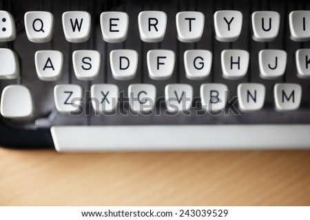 Typewriter qwerty keys on wooden desk