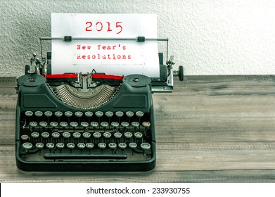 Typewriter With White Paper Page On Wooden Table. Sample Text 2015 New Year's Resolutions. Vintage Style Toned Picture