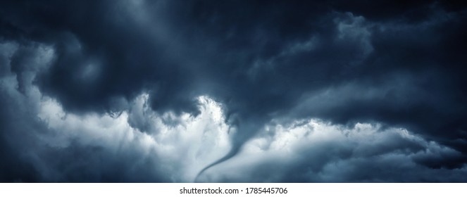 The typhoon is born, a tornado in a stormy dark sky with black clouds. Panoramic image. Concept on the theme of weather, natural disasters, tornadoes, typhoons, tornadoes, thunderstorm.
