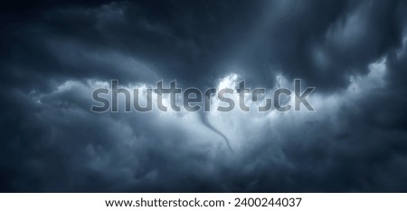 The typhoon is born, a tornado in a stormy dark sky with black clouds and a strong wind. Panoramic image. Concept on theme of weather, natural disasters, tornadoes, typhoons, tornadoes, thunderstorm.