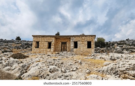 A typical abandoned rustic house made of limestone rocks in the Tekkadin ancient settlement site in Eastern Mediterranean region in Turkey