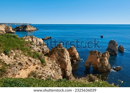 Typical Algarvian landscape with lots of limestone rocks in the water and a deep blue ocean. Portugal