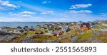 Typical architecture of Greenland capital Nuuk with colored houses located near fjords and icebergs.