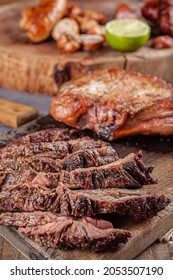 Typical Brazilian Barbecue With Tuscan Sausage, Chicken Sausage, Pork Prime Rib And A Piece Of Sliced Skirt Steak With A Slice Of Lemon On The Side.