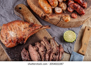 Typical Brazilian Barbecue With Tuscan Sausage, Chicken Sausage, Pork Prime Rib And A Piece Of Sliced Skirt Steak With A Slice Of Lemon On The Side.