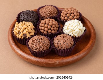 Typical brazilian brigadeiros, various flavors on a wooden plate. - Shutterstock ID 2018401424