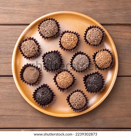 Typical brazilian brigadeiros, various flavors on a brown plate.