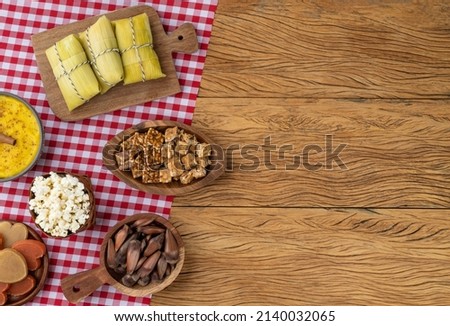 Typical brazilian june festival food over red plaid fabric with copy space. Festa junina.