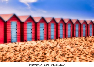 Typical British Beach Huts In Vibrant Colors