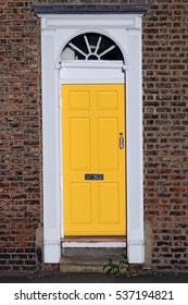 Typical british entrance door painted in yellow