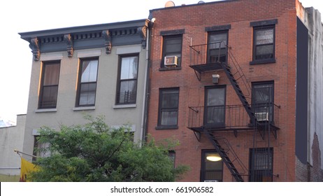 Typical Brooklyn New York City Style Apartment Building Exterior Establishing Shot Outside Fire Escape Facade. Photo Day Time DX Evening Sunset Time