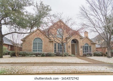 Typical bungalow house under winter snow cover near Dallas, Texas. Middle class residential home in America.