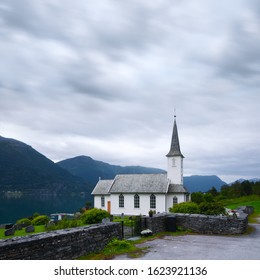 Typical christianity church with cemetery of Nes village, parish church in Luster Municipality in Sogn og Fjordane county, Norway. Lustrafjorden fjord on background. Landscape photography - Powered by Shutterstock