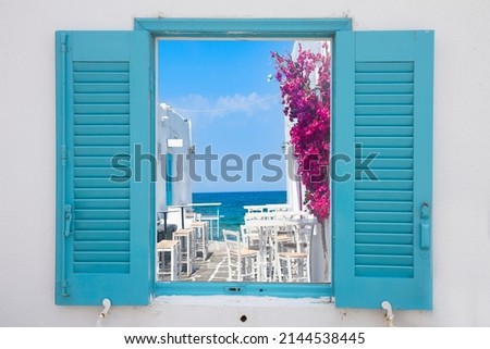 typical coloful white street of Paros island, Greece, view through the window