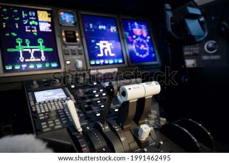 A typical dashboard panel in the cockpit of a private jet plane aircraft. Throttle control lever in focus.