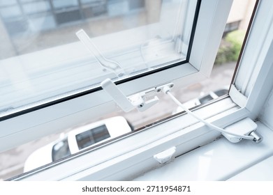Typical double glazed window seen on the first floor of a modern hotel. Note the security cable which prevents the window from opening too much, to prevent falling out.