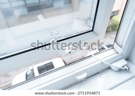 Typical double glazed window seen on the first floor of a modern hotel. Note the security cable which prevents the window from opening too much, to prevent falling out.