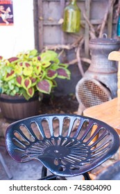 Typical English Pub Garden With Cast Iron Stool And Chimnea In The Background