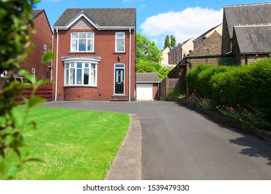 Typical English Single Family House Built Of Red Bricks, With A Large Driveway