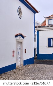 Typical Facade Next To An Empty Street Intersection In The Old Town Of Ericeira, Portugal.