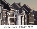 Typical facades of dutch architecture in the city center of Maastricht, Netherlands, with residential buildings, facades of red brick and flats.