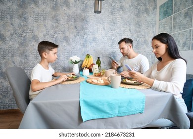 Typical Family With Smartphones At The Dinner Table