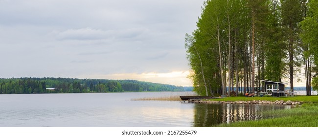 Typical Finnish Little Wooden House Along Lake At The Countryshide