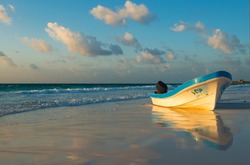Typical Fishing Boat On The Beach Of Tulum At Sunset By The Caribbean Coast Of Mexico.