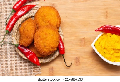 Typical Food From Bahia Called Acarajé Surrounded By Red Peppers And Vatapá