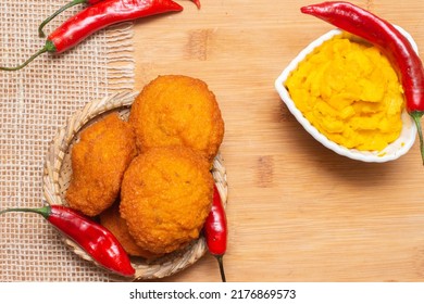 Typical Food From Bahia Called Acarajé Surrounded By Red Peppers And Vatapá