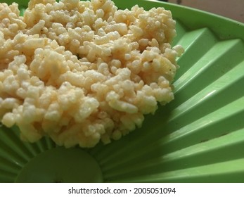 A Typical Food Of East Java Indonesia Called Rengginang On A Green Tupperware Lid