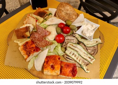 Typical food of Puglia. Focaccia, mozzarella, olives, tomatoes, grilled vegetables, salami and cheeses