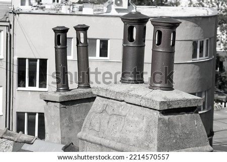Typical four old metallic pipes on a tiled roof in european city, Bratislava, Slovakia. Black and white