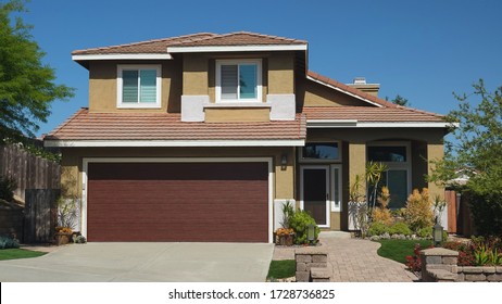 Typical generic suburban single family tract home with built-in garage in California