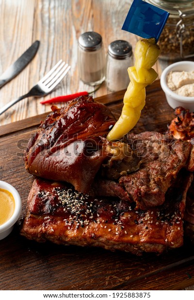 Typical german beer restaurant meals: baked ribs\
with pickled snacks\
around