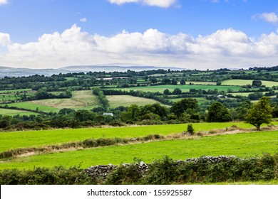 Typical Green Irish Country Side With Rolling Fields And Green Patches