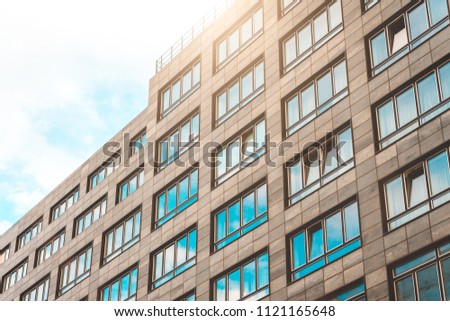 typical grey office building with sunlight on the rooftop